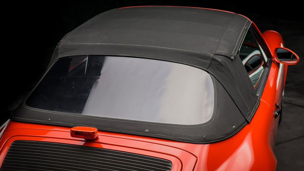 Convertible soft top being cleaned with gentle brush and solution