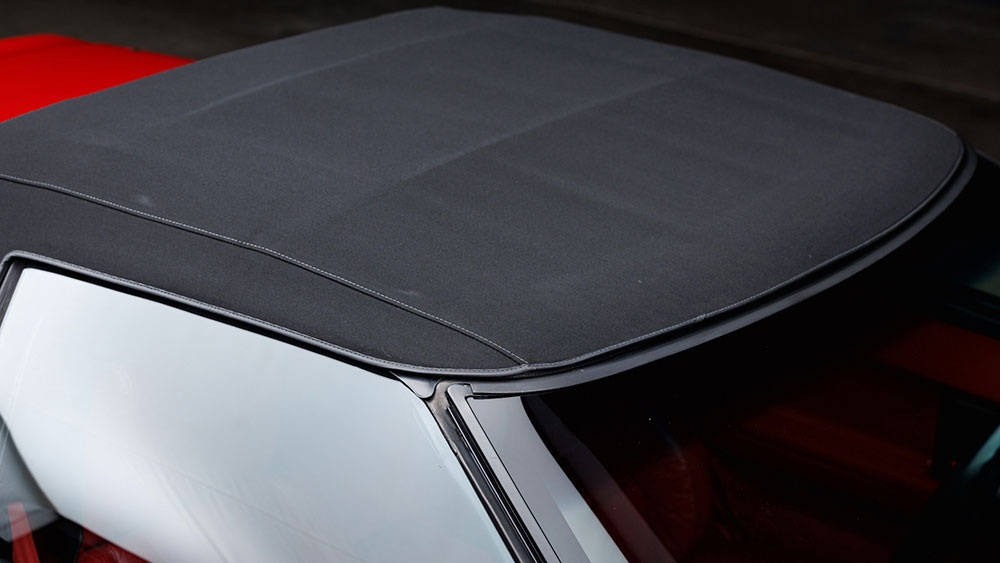 Convertible soft top being restored with fabric-safe color treatment
