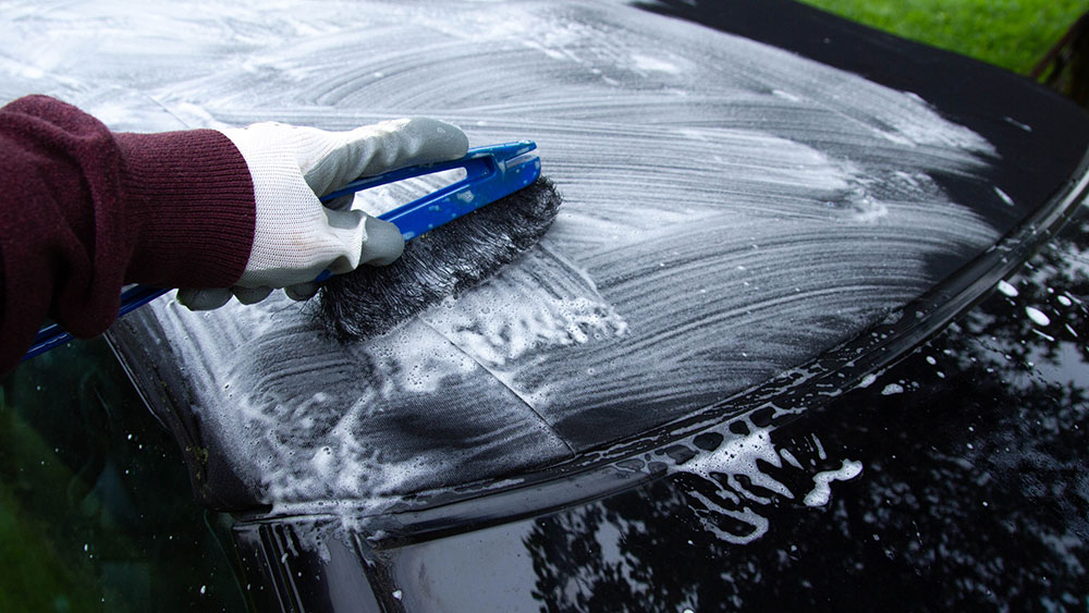 Water beading on a clean convertible soft top after rain