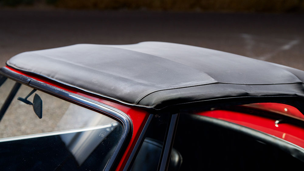 Water beading on a clean convertible soft top after rain