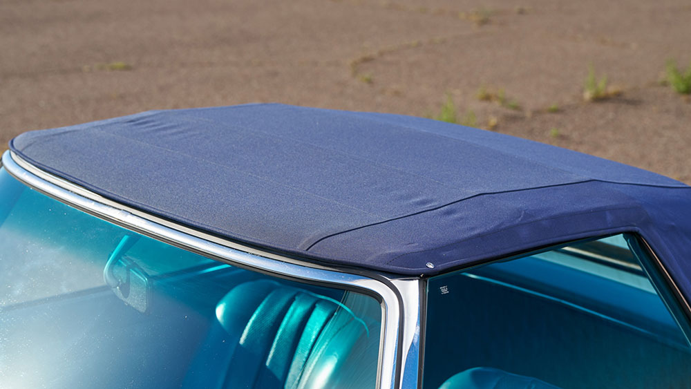 Water beading on a clean convertible soft top after rain