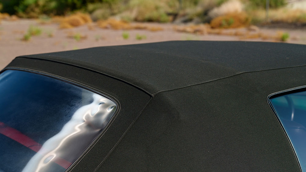 Water beading on a clean convertible soft top after rain